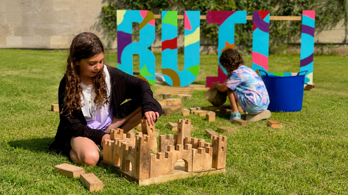 Child playing with building block summer of play Ilam park